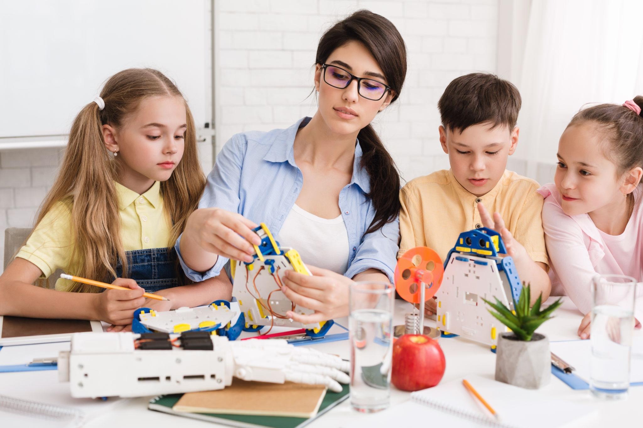 Teacher guiding students through a hands on lesson